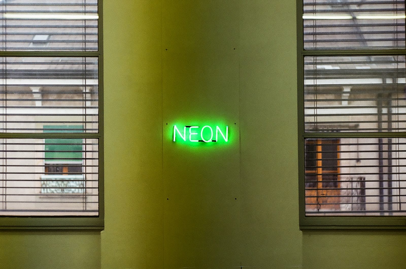 turned on neon signage on wall during daytime